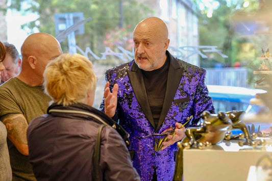 Artmarket Gallery director Robert Power goes to top up Tim Cotterillâ€™s glass of champagne.